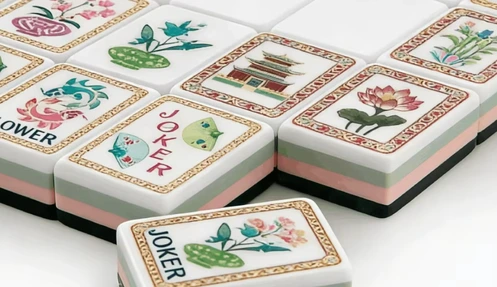 Complete Chinese mahjong tile layout with flower artwork and joker tile